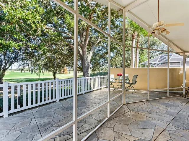 a view of a porch with furniture and a yard