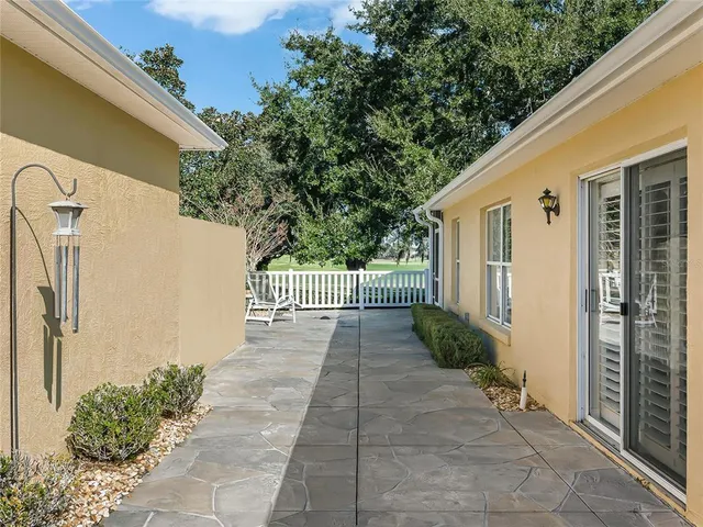 a view of a pathway of a house with a patio
