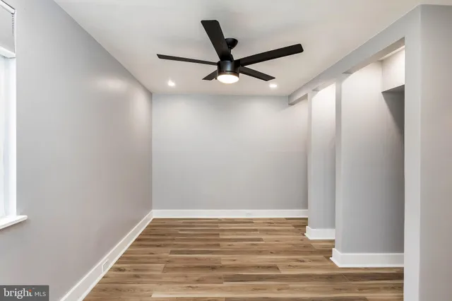 a view of a room with wooden floor and staircase