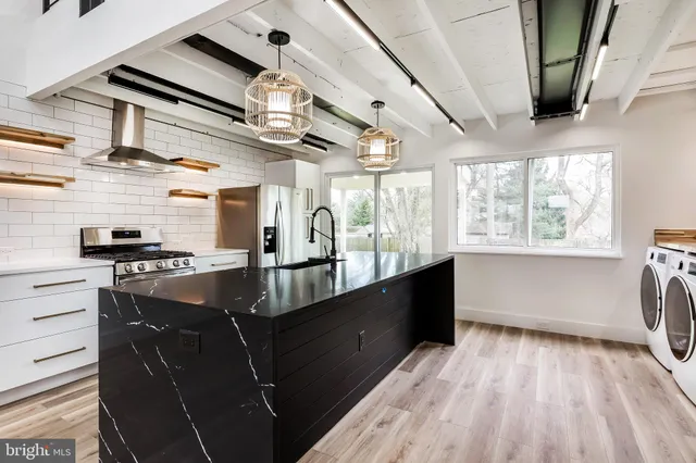 a kitchen with granite countertop a stove and a wooden floors