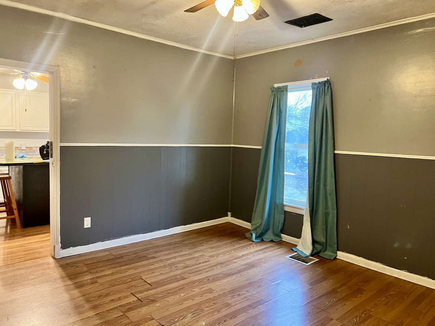 375 West Franklin Street Paxton, IL 60957 - Photo 6 of 43 an empty room with wooden floor a chandelier fan and windows