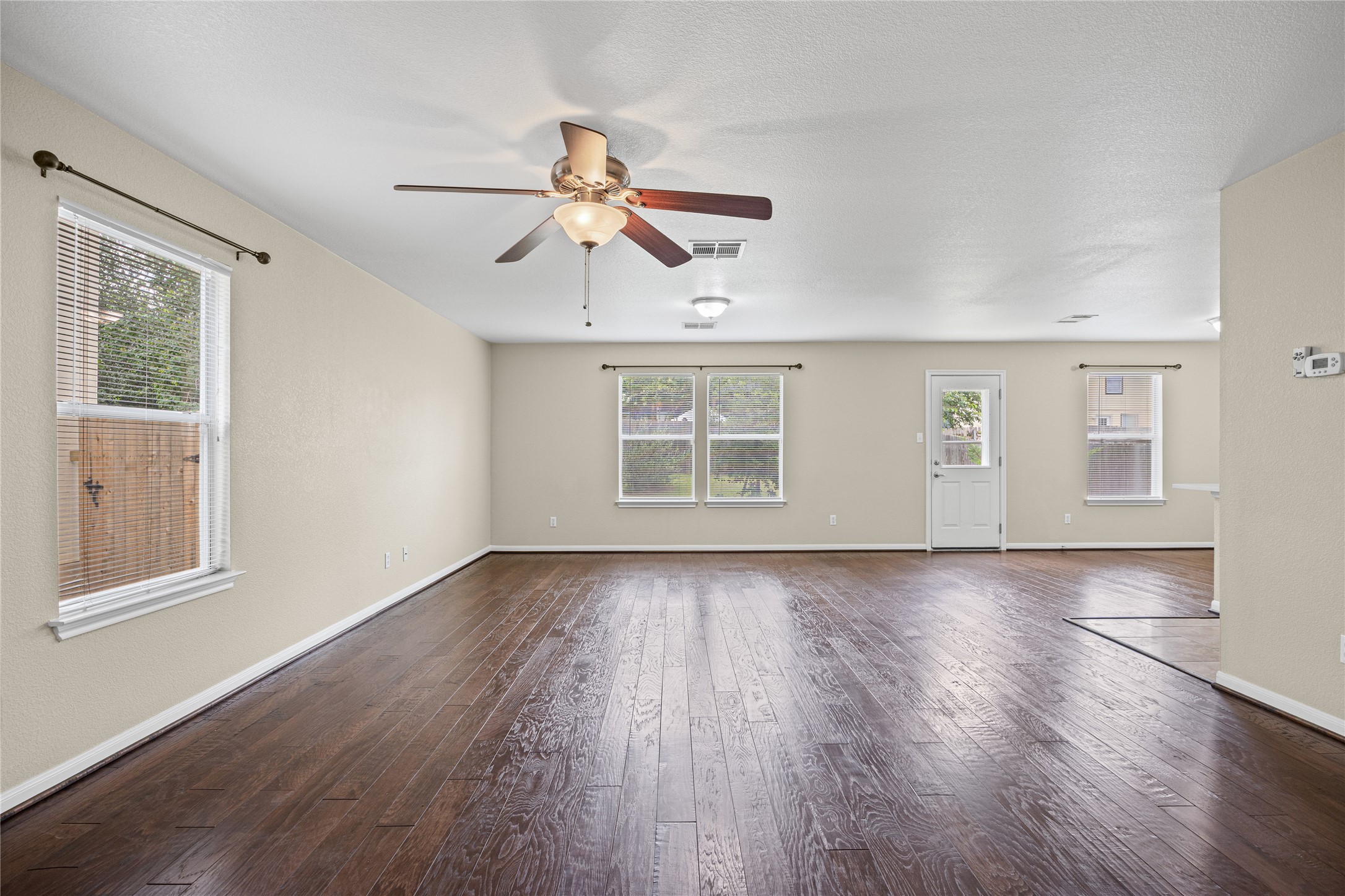 198 Black Forest Road Buda, TX 78610 - Photo 4 of 23 Rich wood floors complement an inviting, naturally lit living area.
