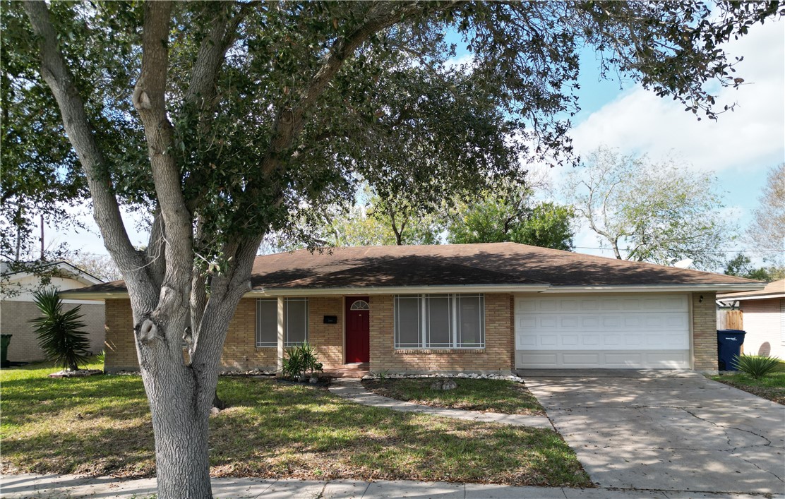 4245 Dody Street Corpus Christi, TX 78411 - Photo 1 of 15 a front view of a house with garden