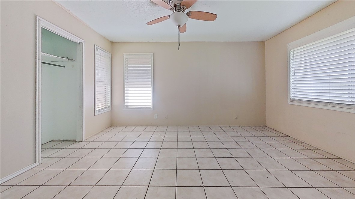 4245 Dody Street Corpus Christi, TX 78411 - Photo 11 of 15 an empty room with windows and fan