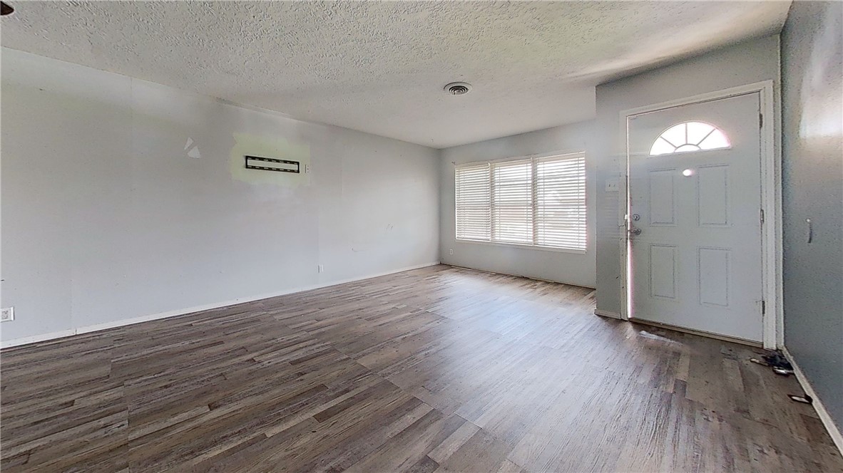 4245 Dody Street Corpus Christi, TX 78411 - Photo 3 of 15 an empty room with wooden floor and windows