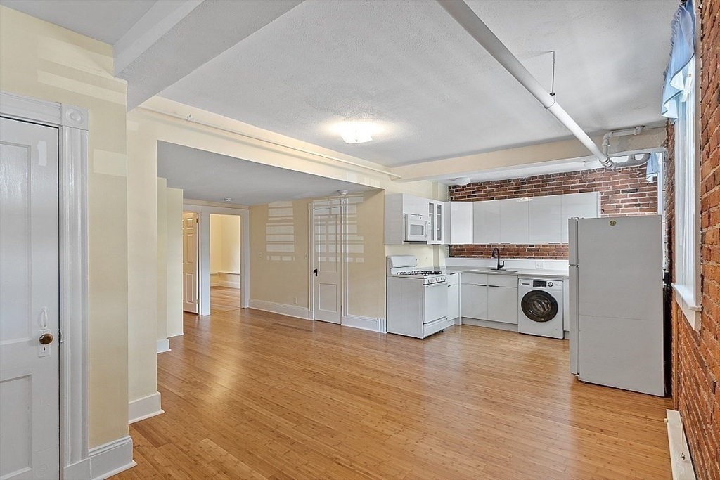 6 Radcliffe Road, Unit B Boston, MA 02134 - Photo 19 of 25 a view of a kitchen with wooden floor