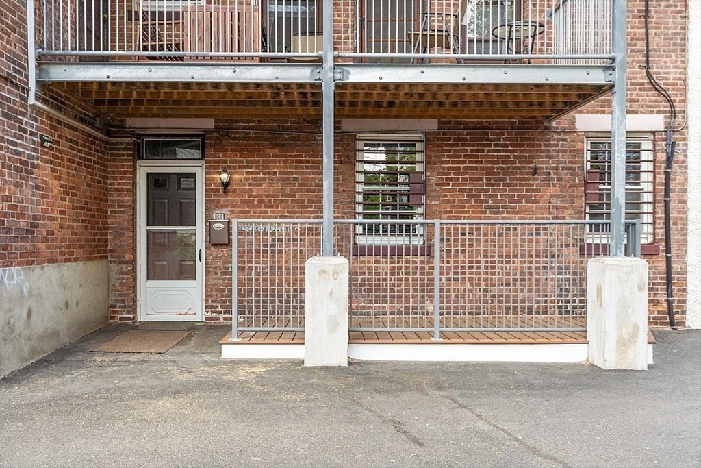 6 Radcliffe Road, Unit B Boston, MA 02134 - Photo 20 of 25 a view of a brick house with a window