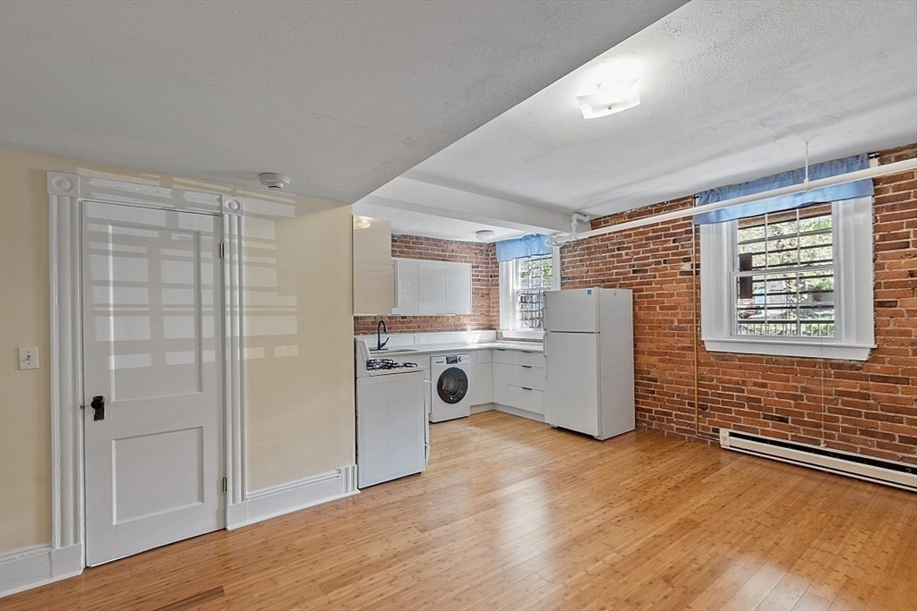 6 Radcliffe Road, Unit B Boston, MA 02134 - Photo 7 of 25 a view of kitchen with stainless steel appliances wooden floor and window