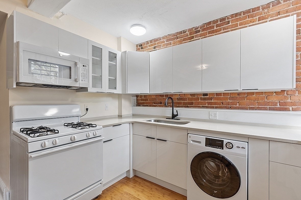 6 Radcliffe Road, Unit B Boston, MA 02134 - Photo 9 of 25 a kitchen with cabinets and appliances