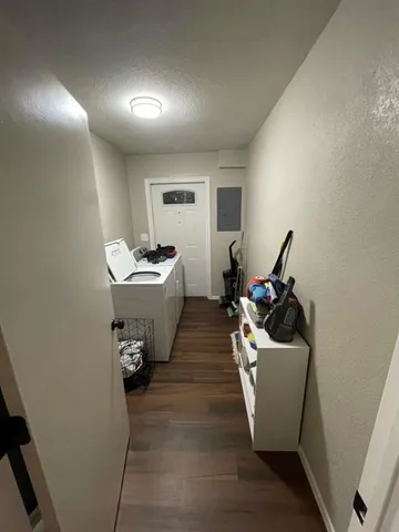 a room with wooden floor and white walls