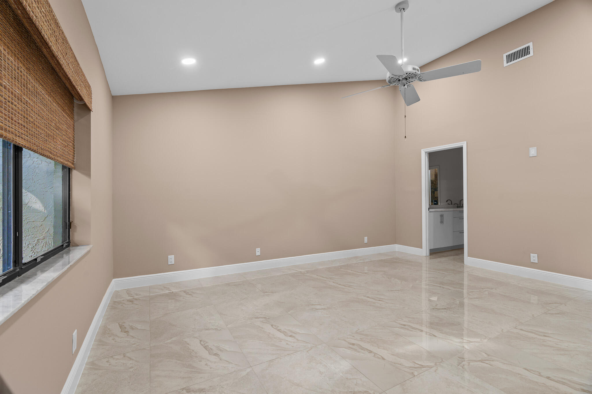 22545 Meridiana Drive Boca Raton, FL 33433 - Photo 23 of 63 a view of an empty room with a fireplace and a window