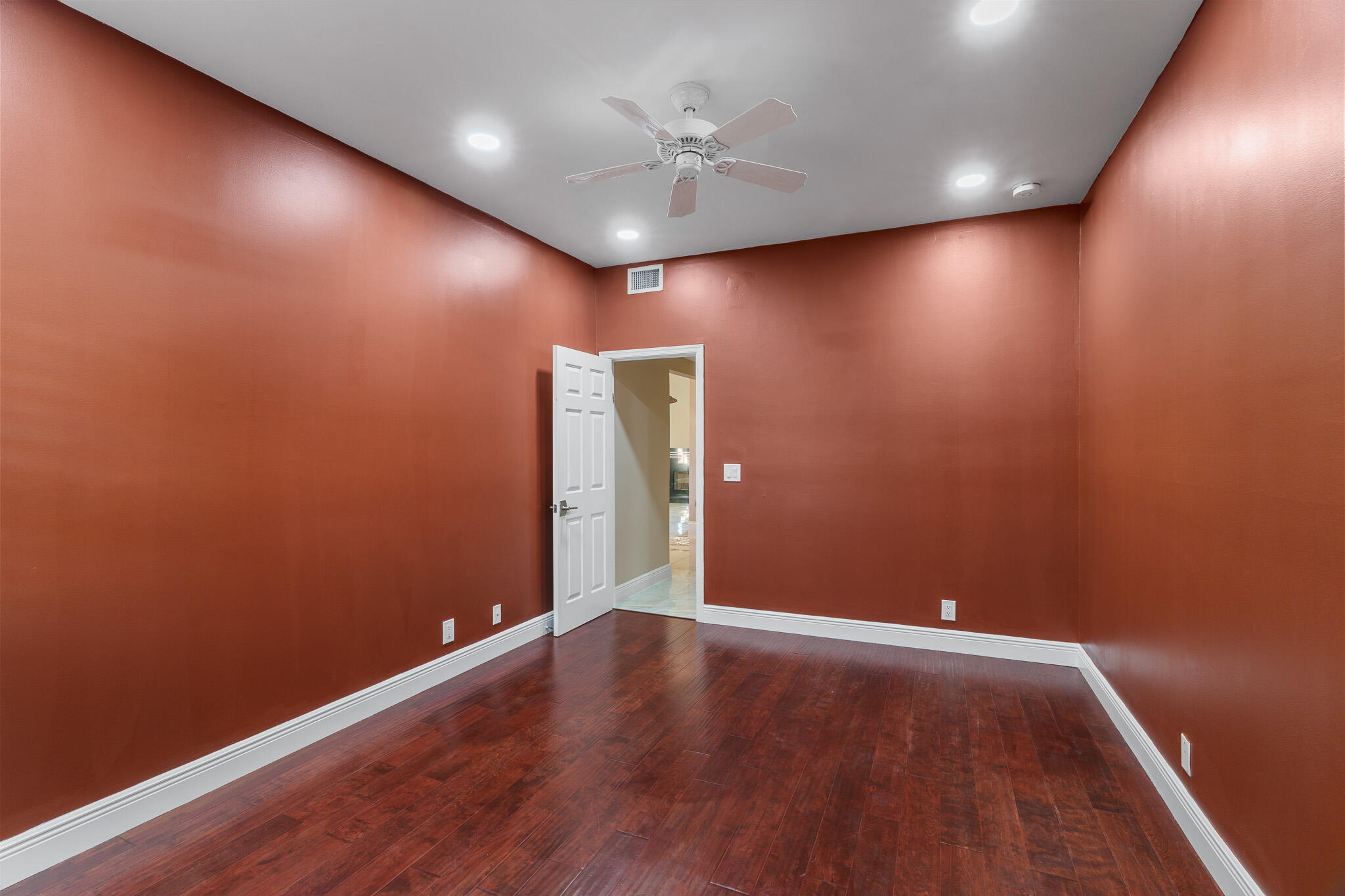 22545 Meridiana Drive Boca Raton, FL 33433 - Photo 33 of 63 an empty room with a ceiling fan and wooden floor