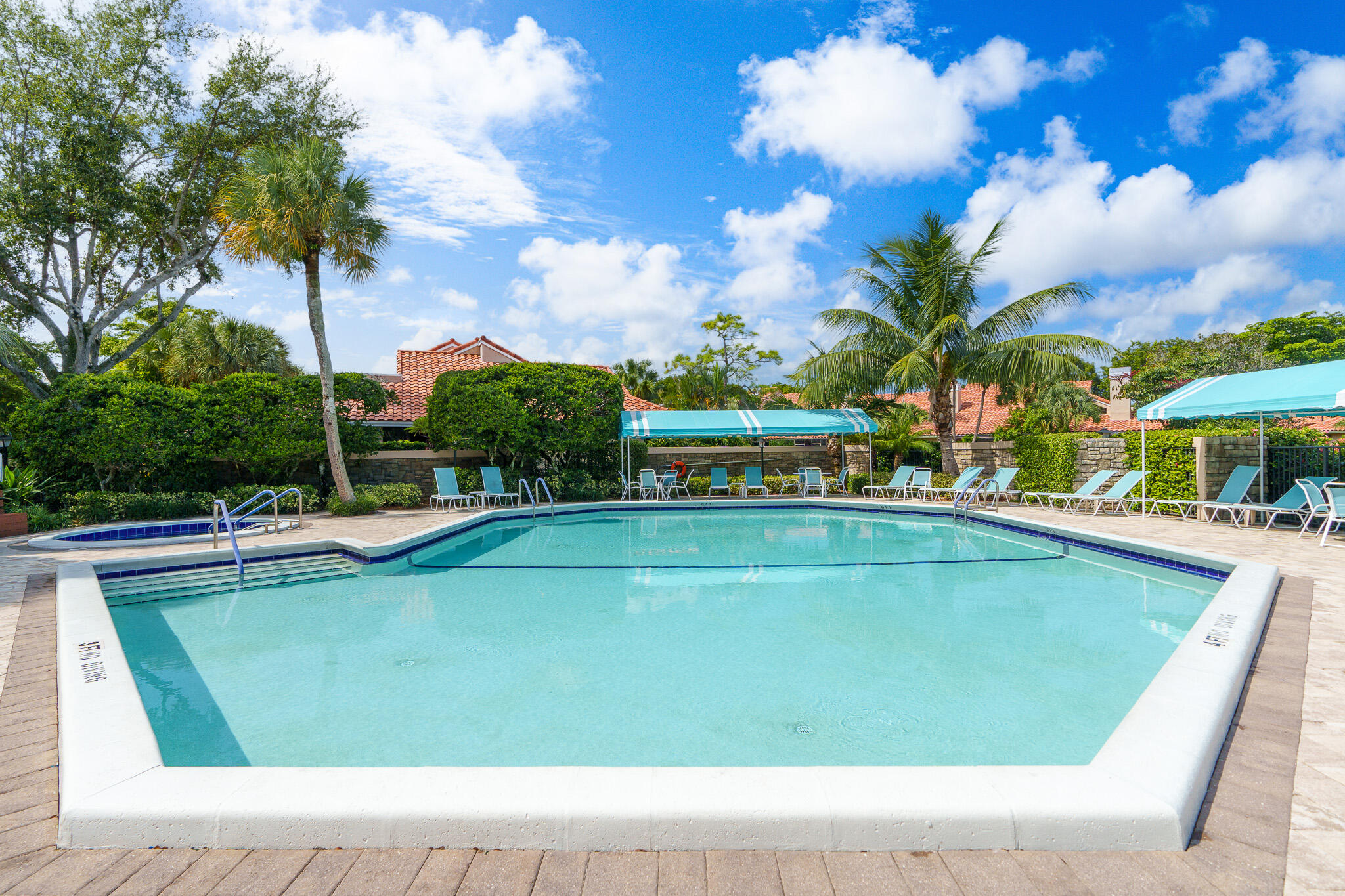 22545 Meridiana Drive Boca Raton, FL 33433 - Photo 40 of 63 a view of a swimming pool with a table and chairs