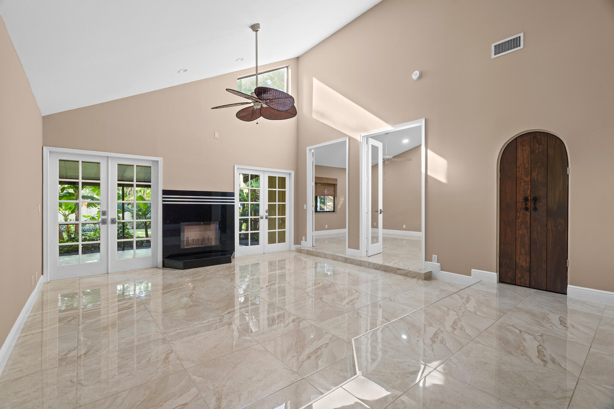 22545 Meridiana Drive Boca Raton, FL 33433 - Photo 5 of 63 a view of an empty room with a fireplace and a window