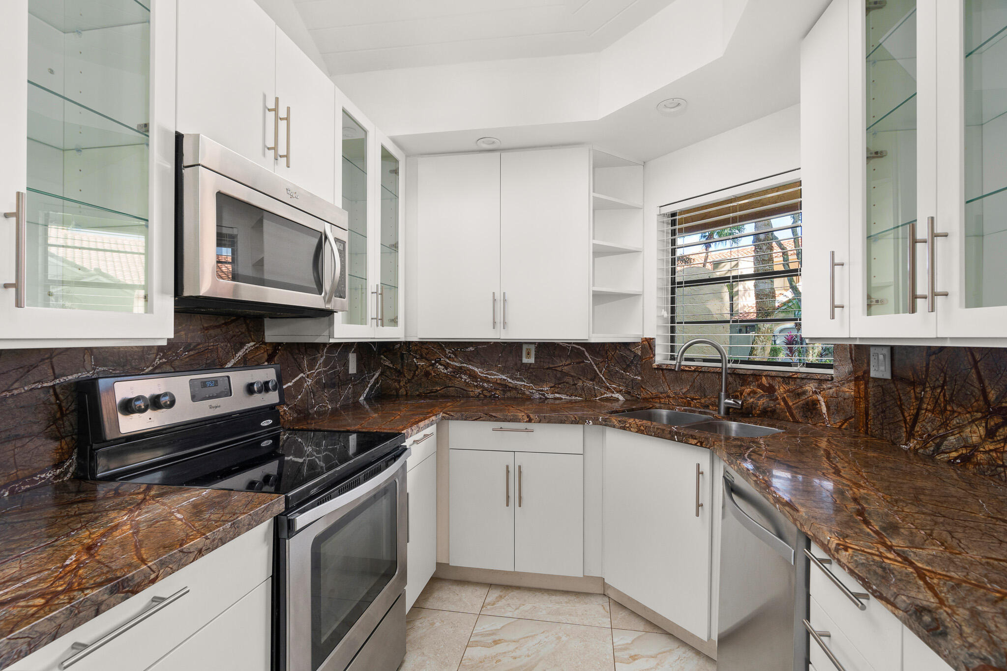 22545 Meridiana Drive Boca Raton, FL 33433 - Photo 9 of 63 a kitchen with stainless steel appliances granite countertop a stove a sink and a microwave