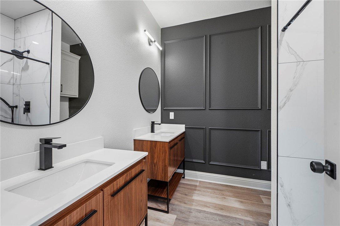 505 Legion Court Bryan, TX 77803 - Photo 10 of 21 a bathroom with a sink and a mirror