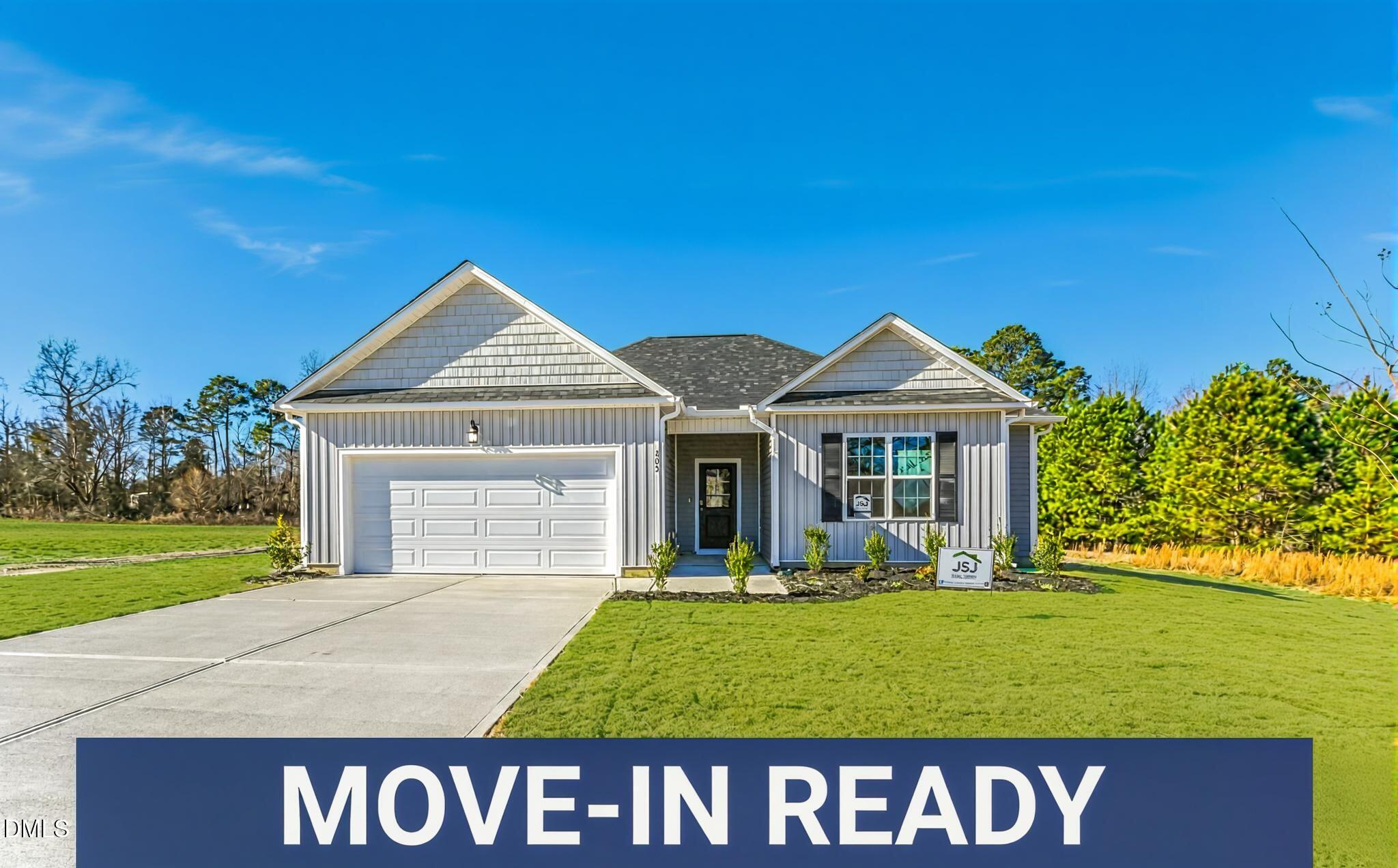 205 Hookbill Lane Lillington, NC 27546 - Photo 1 of 36 a front view of a house with garden and trees