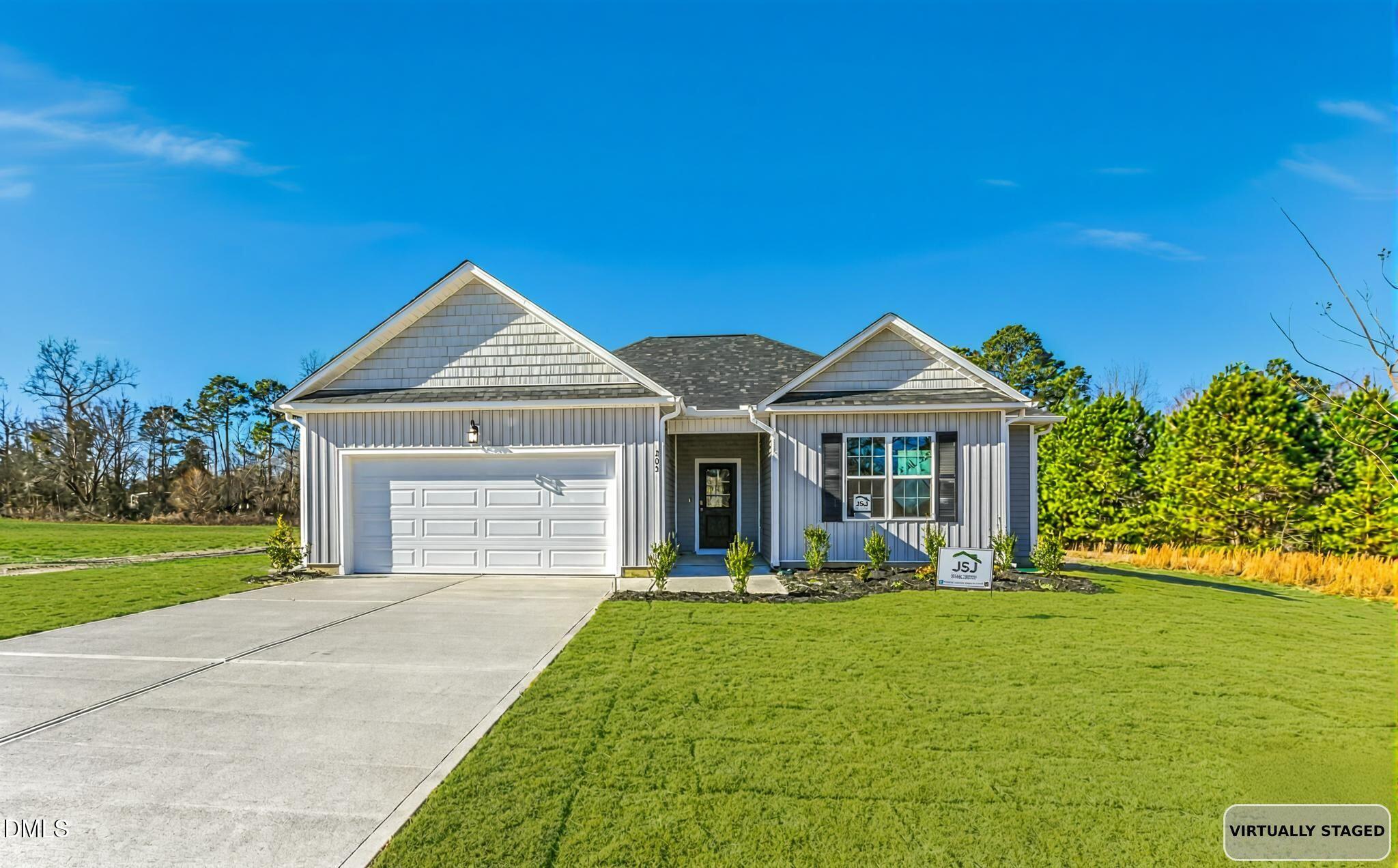 205 Hookbill Lane Lillington, NC 27546 - Photo 33 of 36 a front view of a house with garden and trees