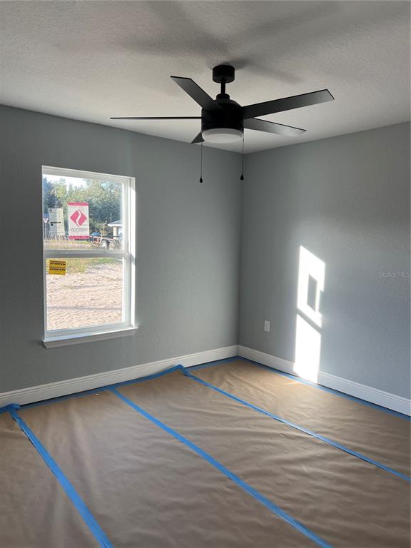 20050 Southwest 80th Pl Road Dunnellon, FL 34431 - Photo 4 of 10 a view of an empty room with wooden floor and a window