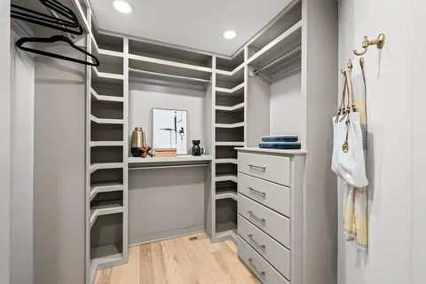 a view of a sink mirror and cabinets