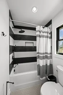 a view of a house with backyard and a tree