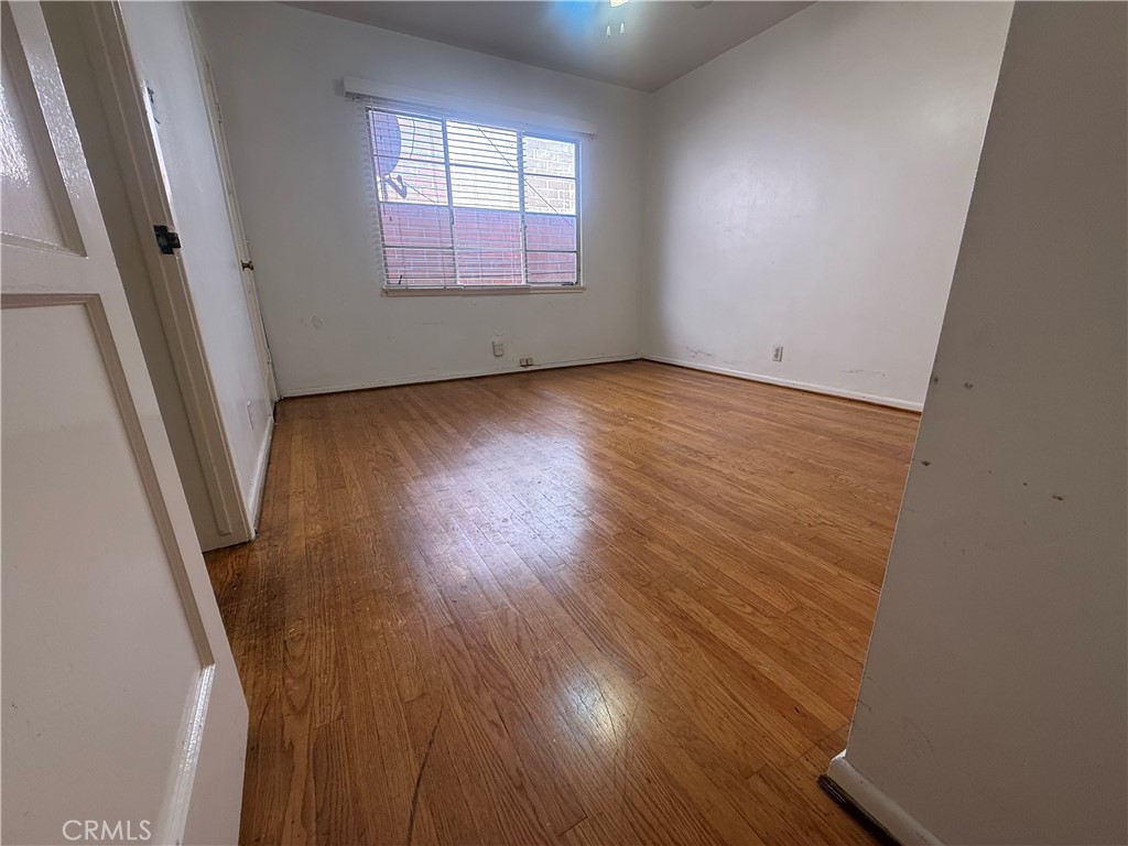 50 Elm Avenue, Unit 11 Long Beach, CA 90802 - Photo 13 of 15 an empty room with wooden floor and windows