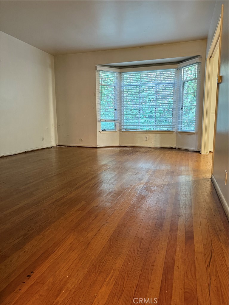 50 Elm Avenue, Unit 11 Long Beach, CA 90802 - Photo 3 of 15 wooden floor in an empty room with a window