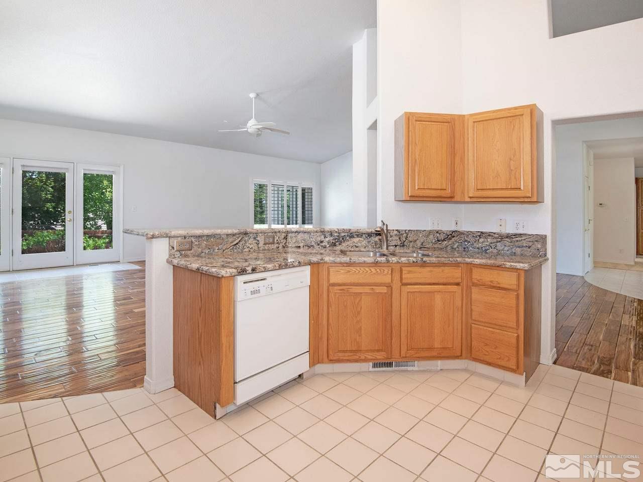 6550 Fieldbrook Circle Reno, NV 89519 - Photo 5 of 21 a kitchen with granite countertop white cabinets and white appliances