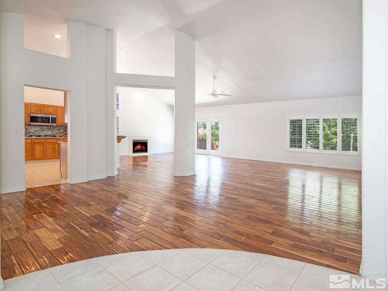 6550 Fieldbrook Circle Reno, NV 89519 - Photo 7 of 21 a view of an empty room with wooden floor and a window