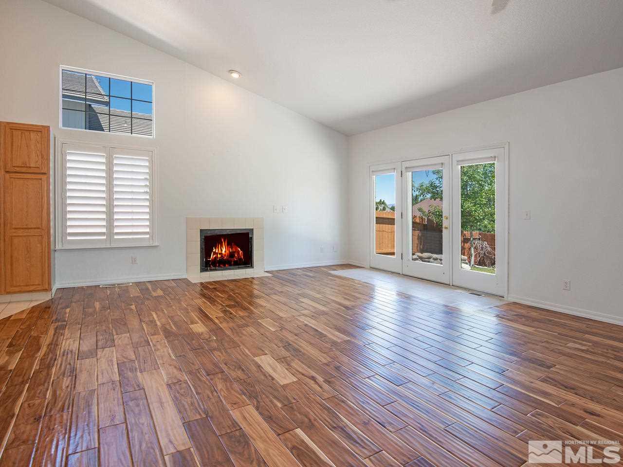 6550 Fieldbrook Circle Reno, NV 89519 - Photo 9 of 21 an empty room with wooden floor and windows