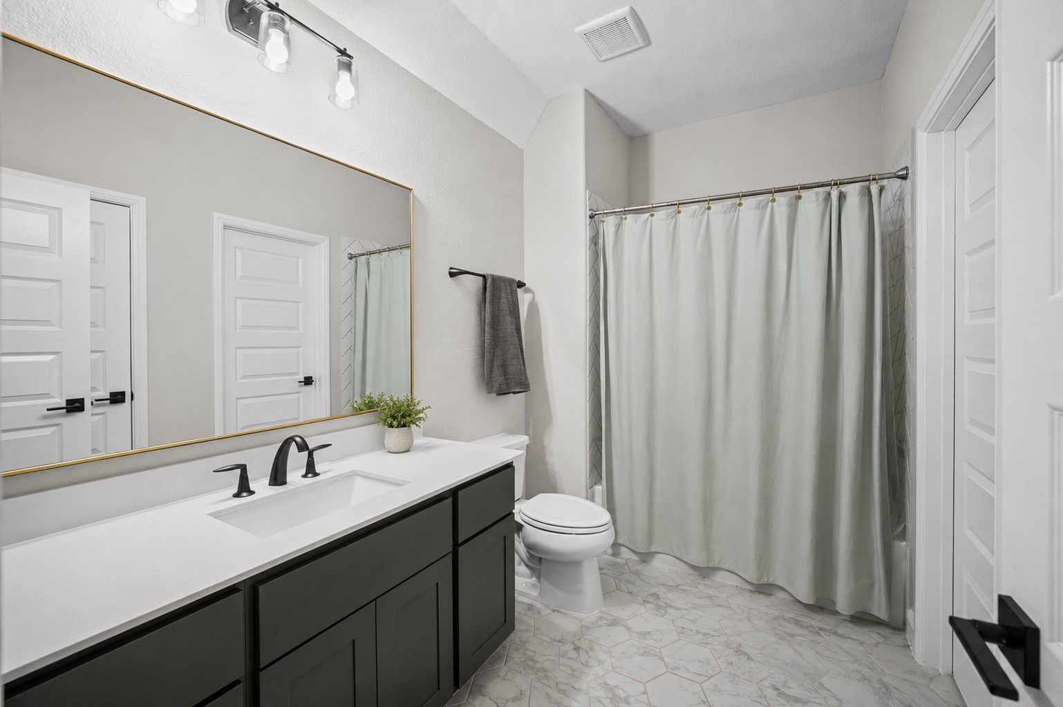 4923 Grapevine Lane Manvel, TX 77578 - Photo 34 of 49 a bathroom with a double vanity sink toilet and a mirror