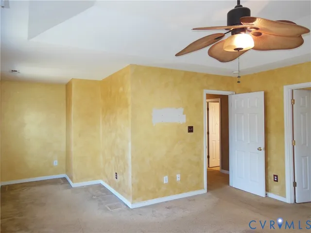 a very nice looking room with a chandelier fan