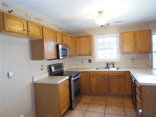 a kitchen with a sink stove and microwave
