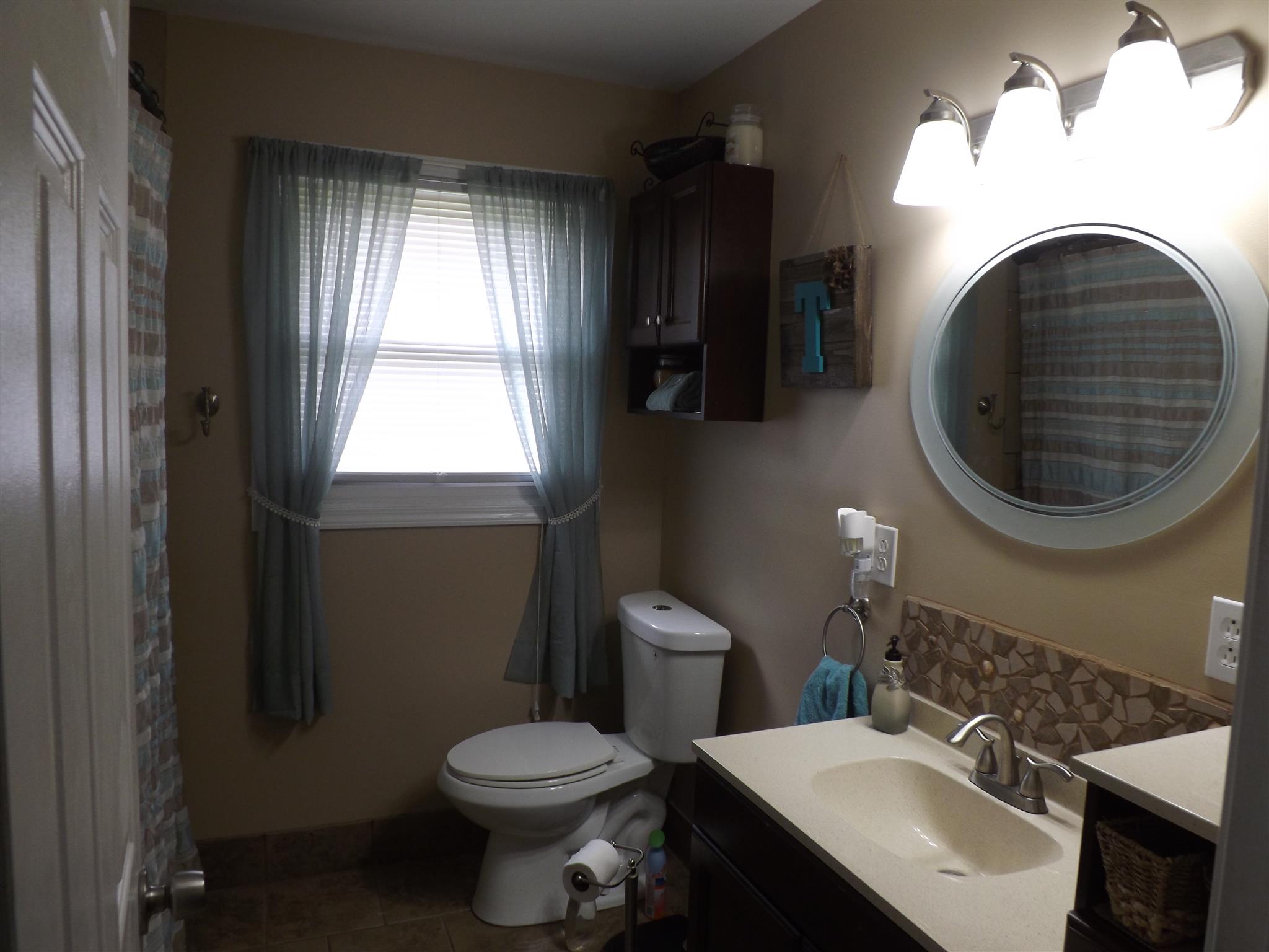 1397 Oak Grove Road Goodspring, TN 38460 - Photo 12 of 25 a bathroom with a sink a toilet and a mirror