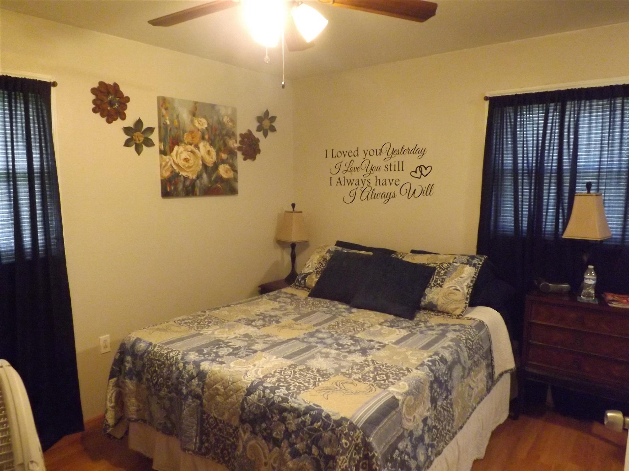 1397 Oak Grove Road Goodspring, TN 38460 - Photo 14 of 25 a bed sitting in a bedroom next to a lamp