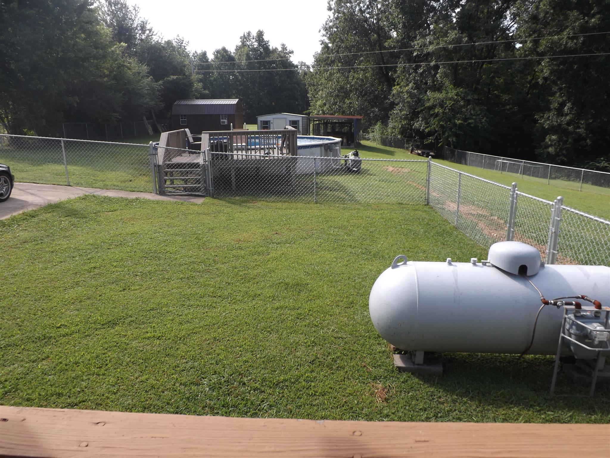 1397 Oak Grove Road Goodspring, TN 38460 - Photo 24 of 25 a view of a backyard with lawn chairs and a fire pit