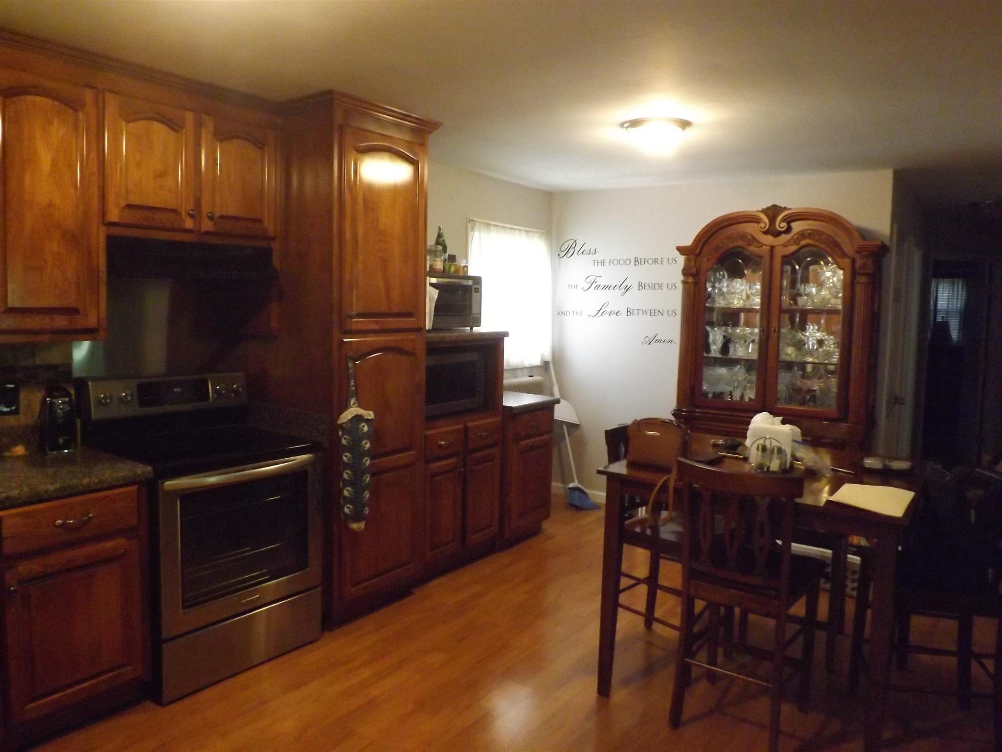 1397 Oak Grove Road Goodspring, TN 38460 - Photo 8 of 25 a kitchen with granite countertop a dining table chairs cabinets a stove and a window