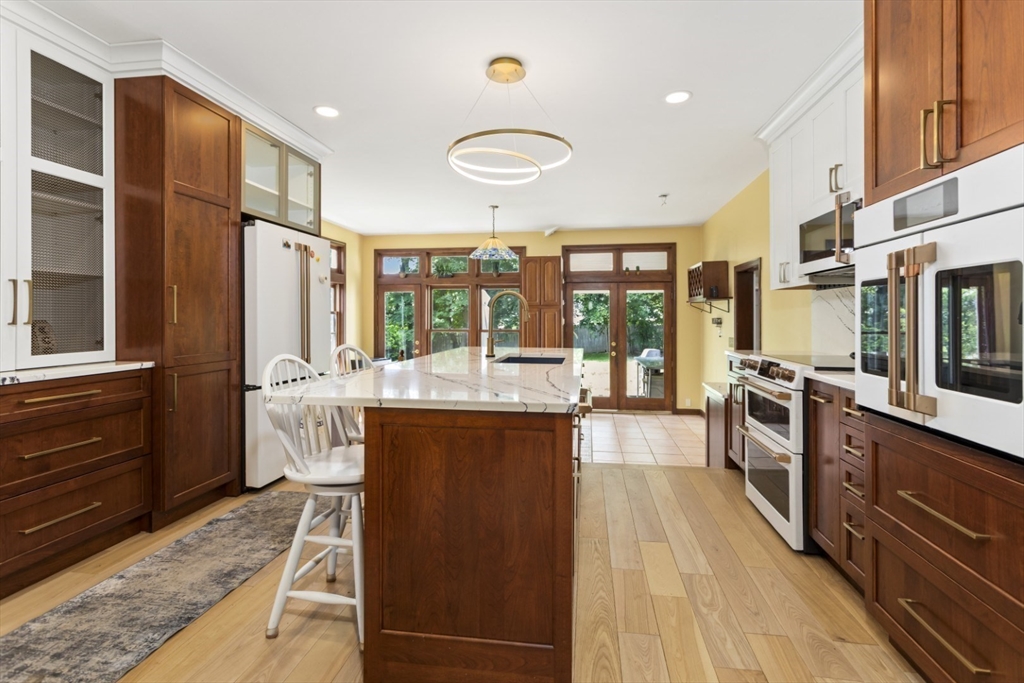 29 Boulevard Road Dedham, MA 02026 - Photo 6 of 34 a large kitchen with stainless steel appliances granite countertop a stove and a refrigerator