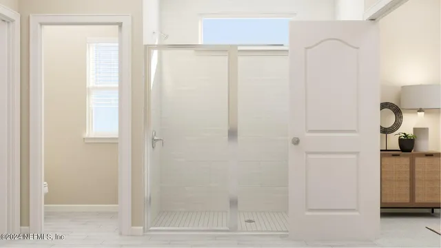 a bathroom with a glass shower door