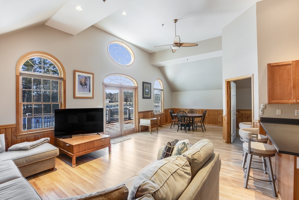 30 Field Road Sudbury, MA 01776 - Photo 13 of 38 a living room with furniture a flat screen tv and a fireplace