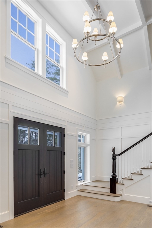 30 Field Road Sudbury, MA 01776 - Photo 16 of 38 a view of a hallway with entryway chandelier and front door
