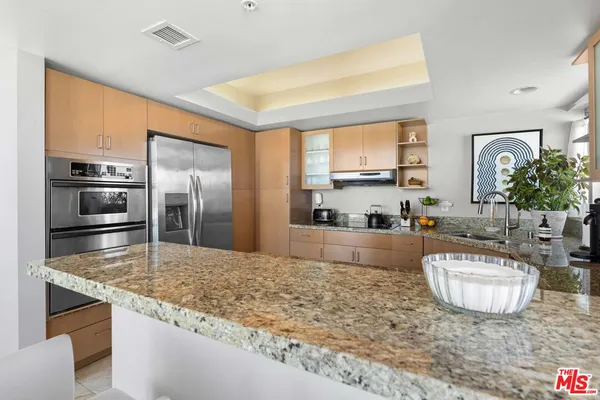 a kitchen with sink refrigerator and microwave
