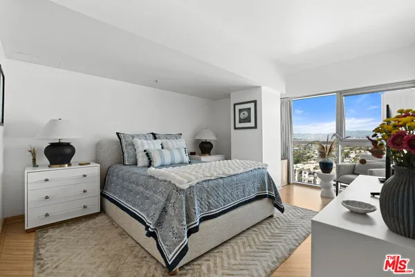 a spacious bedroom with a bed and a couch