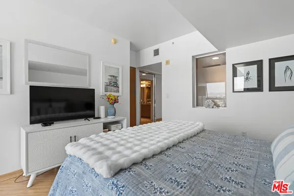 a living room with flat screen tv and a couch