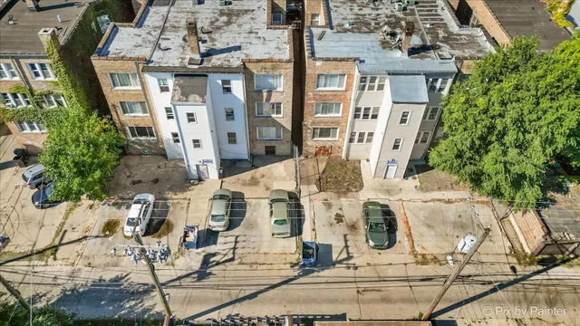 an aerial view of residential building with green space