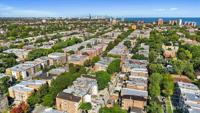 an aerial view of residential houses with city view
