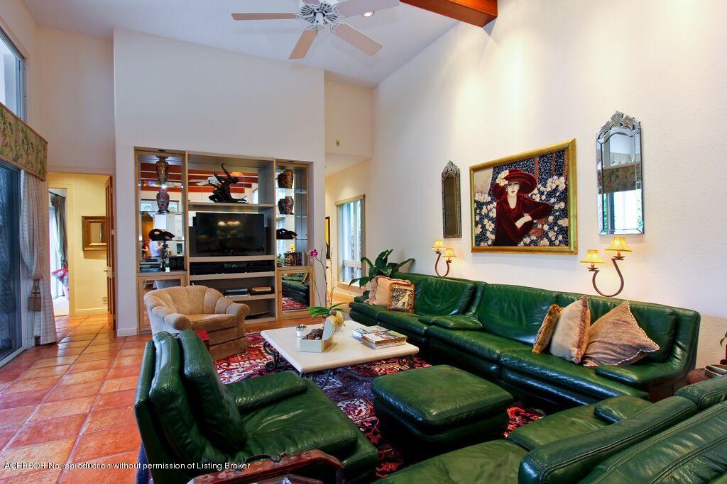 210 Wells Road Palm Beach, FL 33480 - Photo 5 of 12 a living room with furniture a flat screen tv and kitchen view