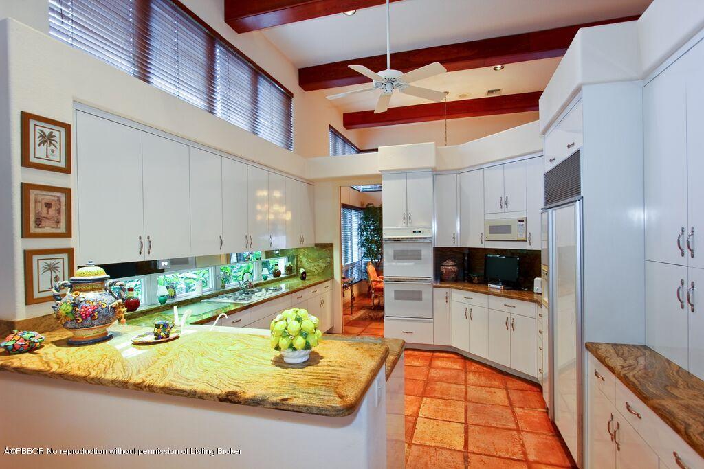 210 Wells Road Palm Beach, FL 33480 - Photo 7 of 12 a kitchen with stainless steel appliances granite countertop a sink and cabinets