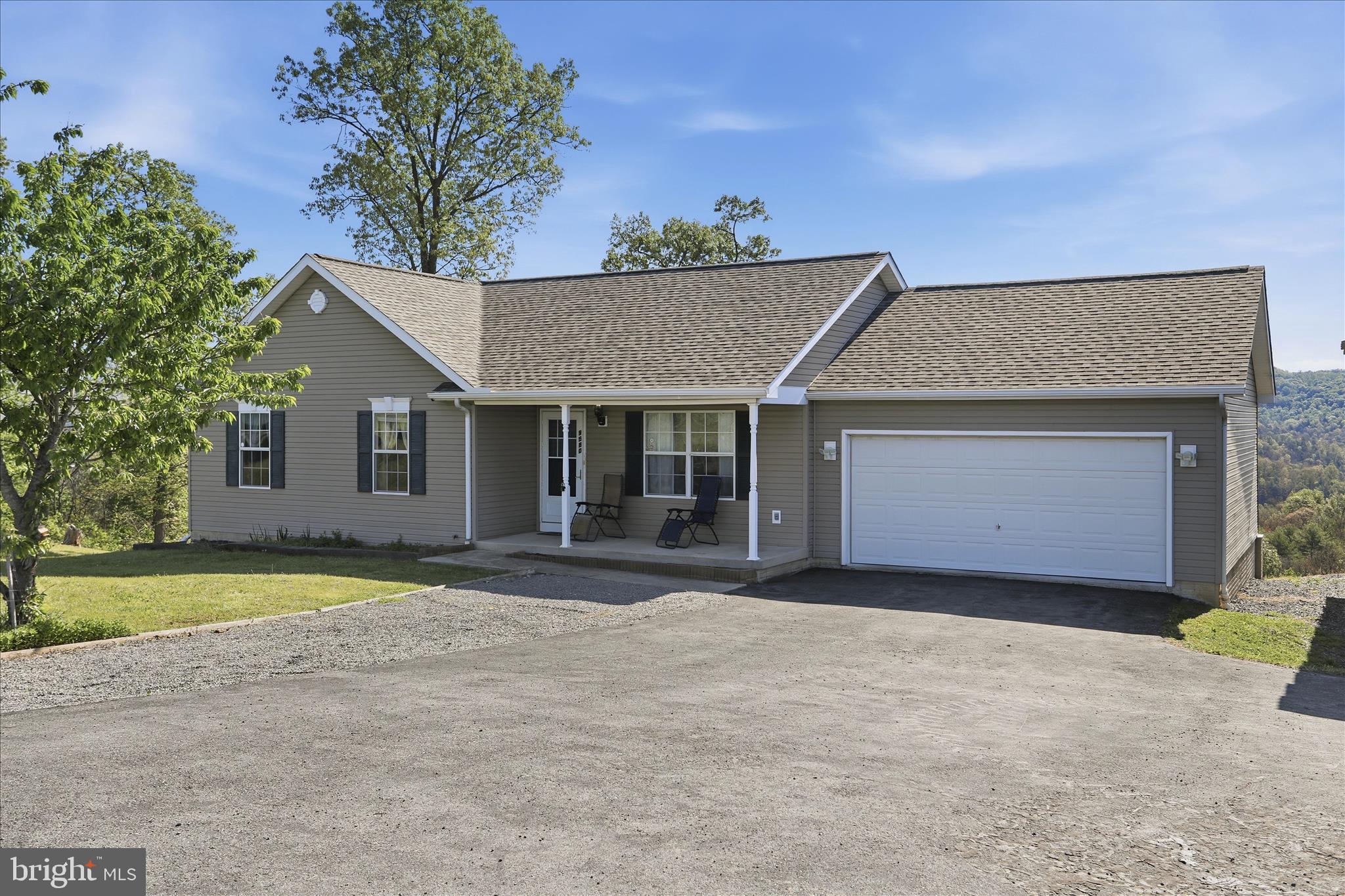 a front view of a house with a garden and yard