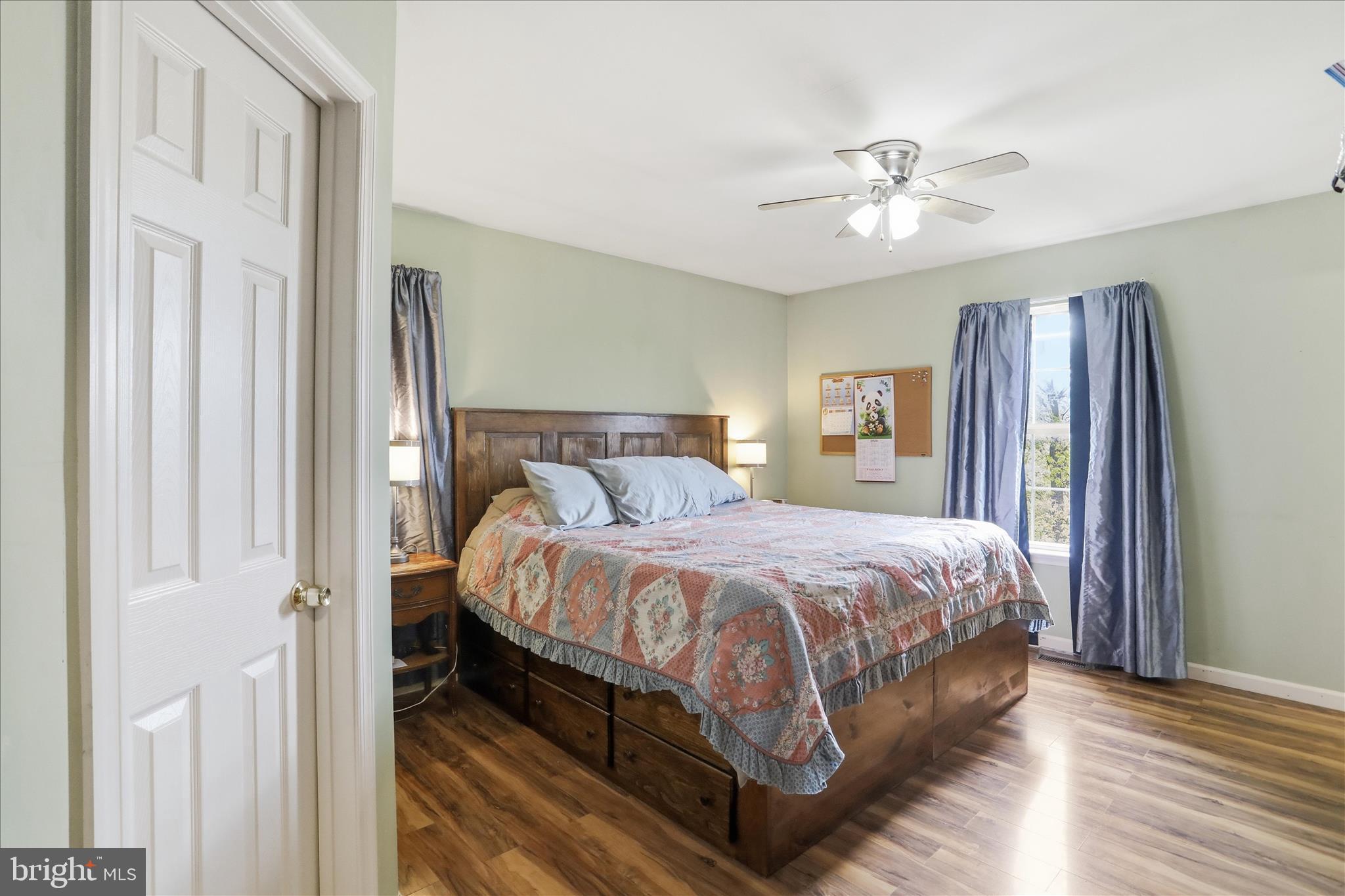 9580 Timber Ridge Road Big Cove Tannery, PA 17212 - Photo 16 of 56 a bedroom with a large bed and a chandelier